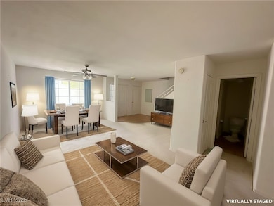 Living room featuring carpet floors and ceiling fa
