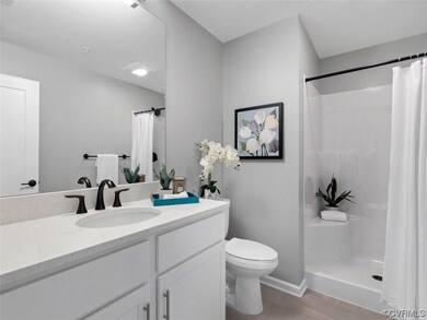 Bathroom with quartz countertops and luxury planke