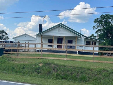 View of front facade featuring covered porch, fenc