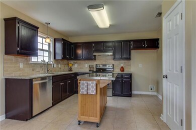The remodeled kitchen has brand new stainless steel appliances and granite.