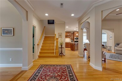 Entrance foyer featuring crown molding and light h