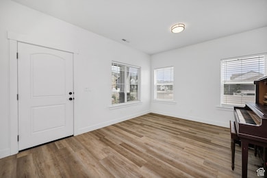 Foyer featuring wood finished floors and baseboards