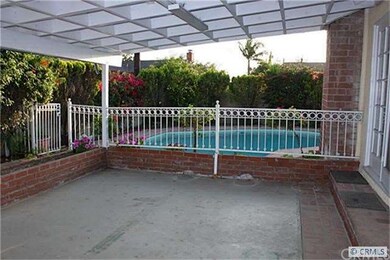 Covered patio and fenced pool.