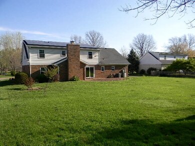 Brick patio over looking the large backyard.