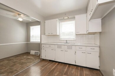 Kitchen featuring dark tile floors, backsplash, an