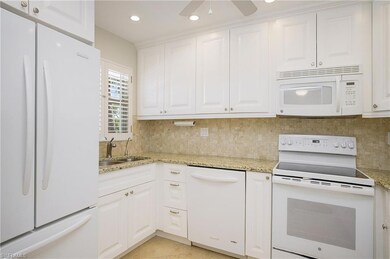 Great white kitchen with granite counters
