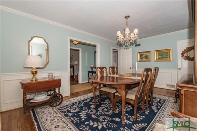 Dining Room with hardwood floors and wainscoting a
