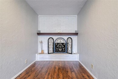 Unfurnished living room with a fireplace, dark har