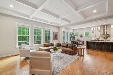 Living room featuring beamed ceiling, light wood-s