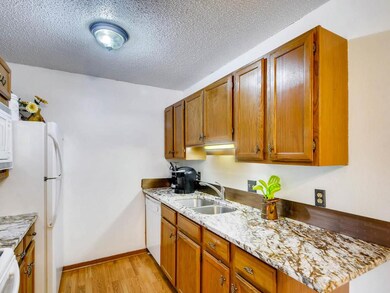 The kitchen has lovely wood laminate floors and up