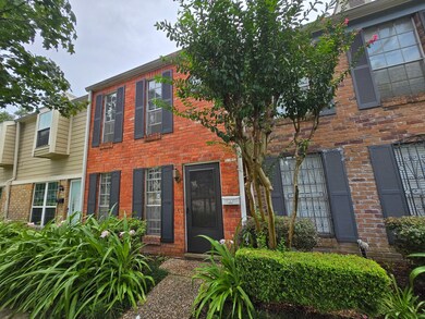 Street facing view: classic brick veneer with lush