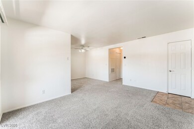 Unfurnished room featuring a ceiling fan, visible