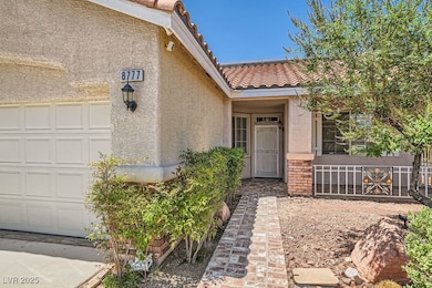Doorway to property featuring a garage, stucco sid