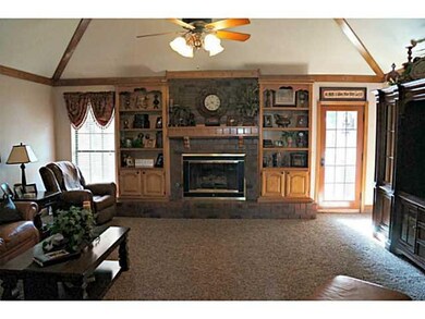 Living Room. Living Room has Vaulted Ceiling, Ceiling Fan & Gas Log Fireplace