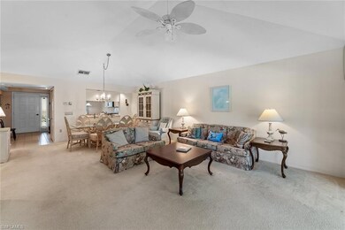 Carpeted living room with lofted ceiling and ceili