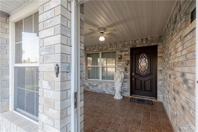 Entrance to property featuring a porch and a ceiling fan