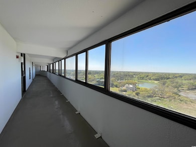 Hall featuring concrete floors and a water view