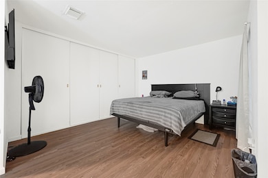 Primary bedroom offers tons of closet space, a sit