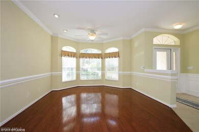 Living Room with Bay Window & Hardwood Floors & Gl