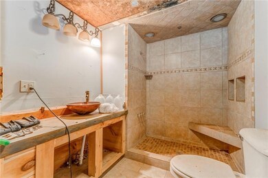Full bath featuring a tile shower, a sauna, and tile patterned floors