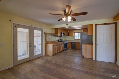 Kitchen featuring french doors, stainless steel appliances, and dark wood-style floors