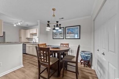Dining space featuring crown molding, light wood-s