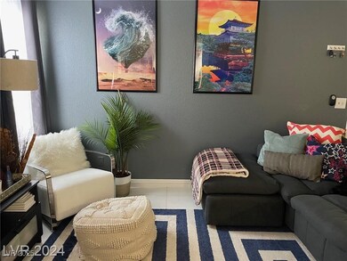 Tiled living area featuring baseboards