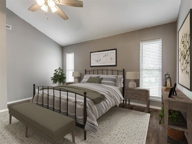 Bedroom featuring ceiling fan, vaulted ceiling, an
