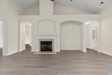 Unfurnished living room with high vaulted ceiling,