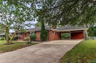 Single story home featuring concrete driveway, a f