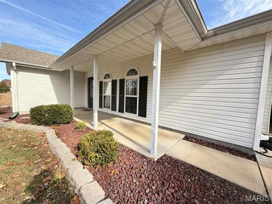 View of exterior entry featuring covered porch