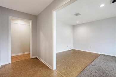 Foyer entrance looks into formal dining/living tha