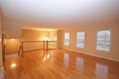 Huge living room features gorgeous hardwood and re