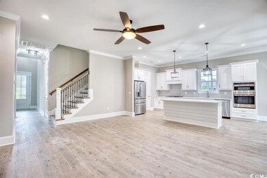 Kitchen featuring white cabinetry, decorative ligh