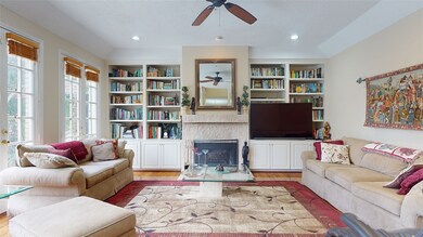 The living room includes custom built-in cabinets,