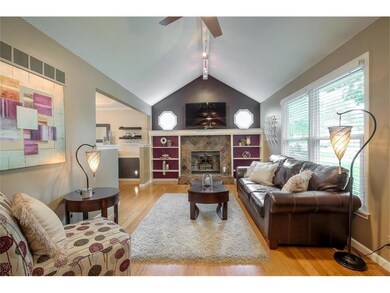 Living room w/fireplace & vaulted ceiling