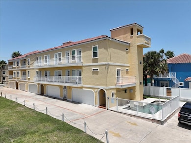 View of building exterior with fence, an attached garage, and driveway