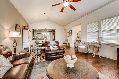 Living room featuring a chandelier, a ceiling fan