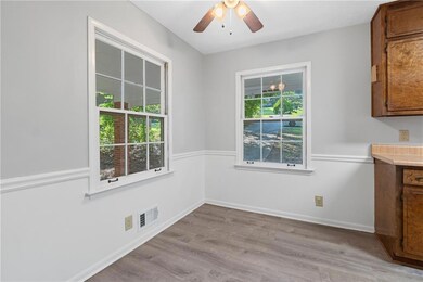 Eat In Kitchen area with healthy amount of natural light, light wood-style flooring, and a ceiling fan