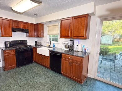 Kitchen featuring visible vents, black appliances,