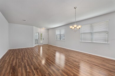 Spare room with wood finished floors and a chande