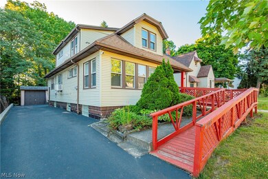 View of front facade featuring a garage and an outdoor structure