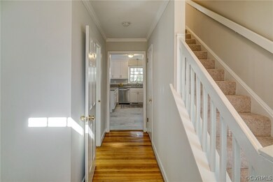 Foyer to kitchen and powder room on the left