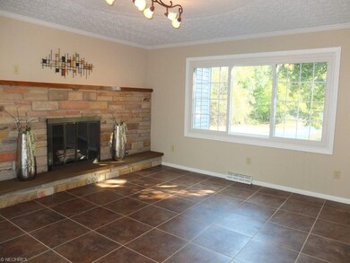 Family room with wood burning fireplace.