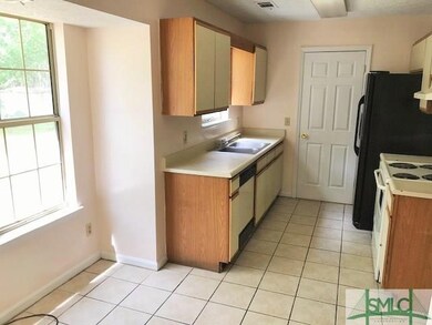 Fully equipped kitchen offering tile flooring, pan
