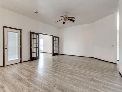 Spare room featuring ceiling fan, french doors, an