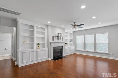 Family room features a wall of beautiful built-in 