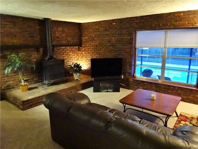 Cozy fireplace and family room looking out to the 
