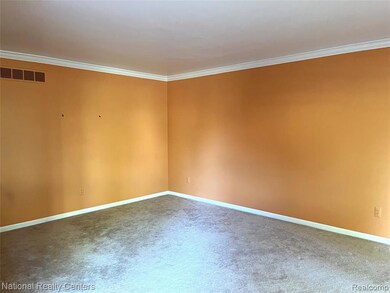 Empty room with ornamental molding and carpet floors