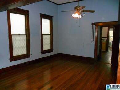 Tall windows and view toward kitchen